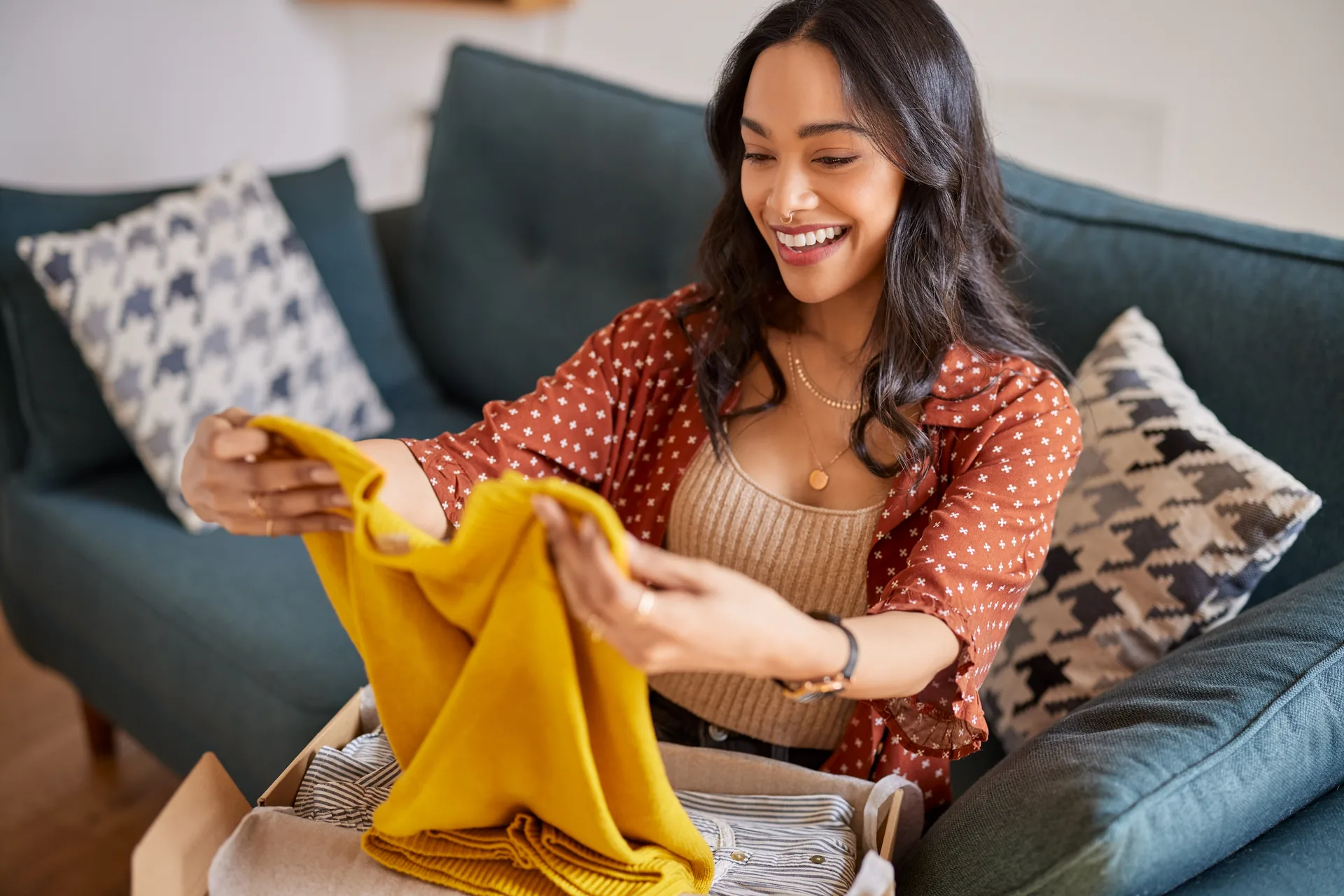 Happy buyer unboxing a mustard shirt purchased on Newish
